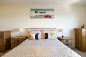 a bedroom with a bed with two nightstands and avertisement at Basingstoke Central Apartments in Basingstoke
