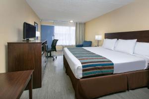 A bed or beds in a room at Days Inn by Wyndham Natchez