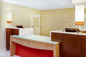 a salon with a reception desk in a room at MainStay Suites Greensboro in Greensboro