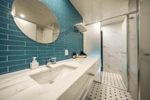 a bathroom with a sink and a mirror at Brown Dot Hotel Signature in Busan