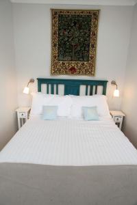 
a bed with a white comforter and pillows at Micro Barn Barnard Castle The Crown pub is not open at present in Mickleton
