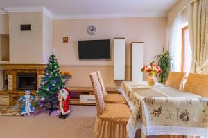 a living room with a christmas tree and a table at Petros Hotel in Bukovel