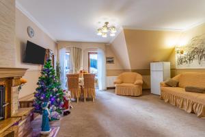 a living room with a christmas tree in a room at Petros Hotel in Bukovel