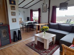 a living room with a couch and a table at Bie Oans Oefje in Lewedorp