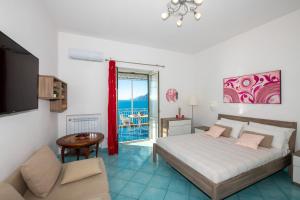 a bedroom with a bed and a couch and a table at Casa Gilda Positano in Positano