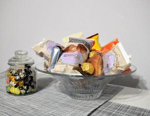 a bowl of snacks and a jar of candy at Azur Apartment Sirmione in Sirmione