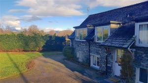 an overhead view of a stone house with a driveway at Beautiful 3-bed stone barn in idyllic Hawkshead in Hawkshead