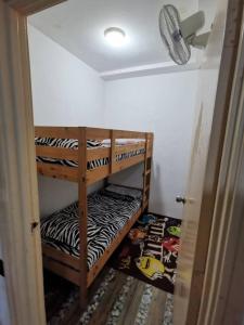 a room with two bunk beds in a room at D'Sofiya Homestay A Famosa Melaka in Melaka