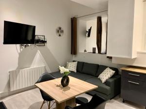 a living room with a couch and a table at Appartement T2 centre-ville -003 in Rouen