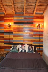 a bedroom with a bed with a wooden wall at Palheiro do Malgas in Lousã