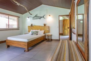 a bedroom with a bed in a room at The Jaguars Jungle Rainforest Lodge - All meals included in San Pedrillo