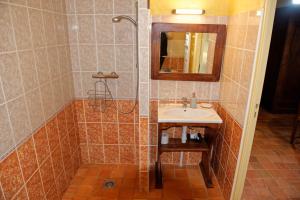 a bathroom with a sink and a shower with a mirror at Chambre d'hotes Au Vieux Moulin in Clohars-Carnoët