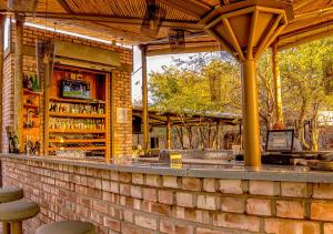 a bar with a brick wall at Etosha Village Campsite in Okaukuejo