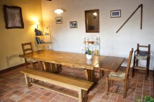 un tavolo in legno e panche in una stanza di Chambre d'hotes Au Vieux Moulin a Clohars-Carnoët