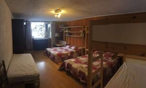 a bedroom with two bunk beds and a window at Boost Your Immo Chalet Vars 371 in Vars
