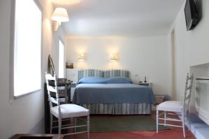 Un pat sau paturi într-o cameră la Villa Torre Dello Ziro