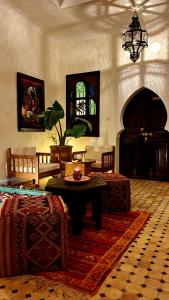 a living room filled with furniture and a large window at Dar Salam Palm in Marrakesh