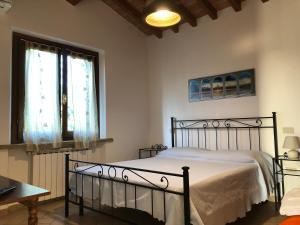 a bedroom with a bed and a window at Agriturismo Ferri in Bibbona