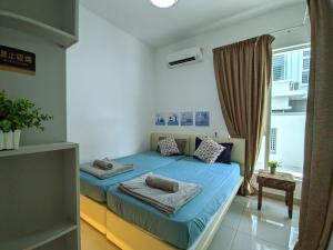a bedroom with a blue bed and a window at Lux Villa 6rm 12 to 22 pax Wifi Netflix BBQ SteamBoat Games Beach Water Park in Desaru +123 photos