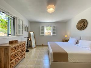 a bedroom with a large bed and a window at Seaside Naxos • Holiday Villas in Plaka