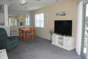 a living room with a television and a kitchen at 1107M condo in Iredell