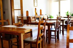 a dining room with wooden tables and chairs at Casa do Lago - Geres in Geres