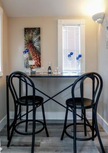 two black chairs sitting at a desk in a room at Meranova Guest Inn in Dunedin