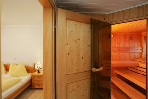 a bedroom with a bed and a wooden closet at Penthouse White Schmitten in Zell am See