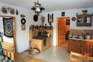 una cucina con camino in mattoni e lavandino di Dom w Uhryniu a Uhryń