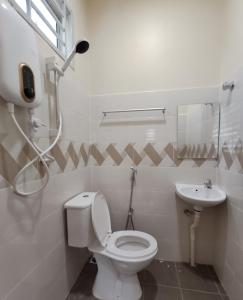 a bathroom with a toilet and a sink at MUSLlM ONLY Wifi 3 Room with 2 aircond Menanti Village Homestay in Alor Setar