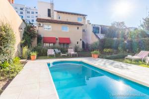 a swimming pool in the backyard of a house at Delvino Boutique Hotel in Salta