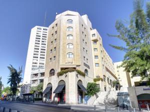 a tall brick building on a city street at Lev yerushalayim - suites hotel in Jerusalem