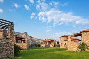 a group of houses with mountains in the background at Agroktima in Leonidio