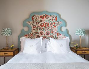 a bedroom with a large bed with a large headboard at La Sacristía in Tarifa