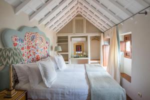 a bedroom with a large white bed in a room at La Sacristía in Tarifa