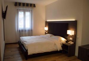 Postel nebo postele na pokoji v ubytování Hotel Villa Fosine