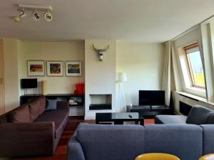 a living room with two couches and a table at Marnix Top: 8P near Leidsche in Amsterdam