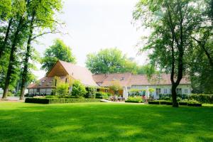 a house with a green lawn in front of it at B&B Weselo in Mol