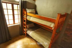 two bunk beds in a room with a window at Casa Camacho in Marloth Park