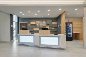 a lobby with a counter with boxes on it at Holiday Inn Express & Suites - Collingwood in Collingwood