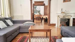 a living room with a couch and a table at VILLA SEQUOIA in Jausiers