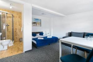 a hotel room with a bed and a bathroom at Przyjaciół 13 in Mielno +50 photos