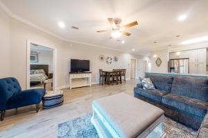 a living room with a blue couch and a table at Cotton Creek #1102 in Gulf Shores