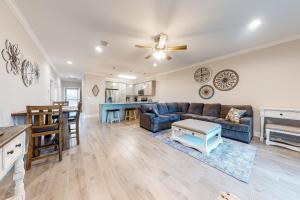 a living room with a couch and a table at Cotton Creek #1102 in Gulf Shores