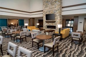 a hotel lobby with tables and chairs and a fireplace at Staybridge Suites - Nashville - Franklin, an IHG Hotel in Franklin