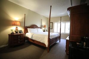 a bedroom with a four poster bed and a window at Legacy Hotel at IMG Academy in Bradenton
