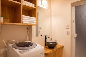 a kitchen with a bowl on top of a washing machine at 瀬戸風月 in Takamatsu