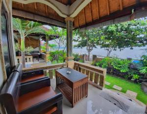 a living room with a couch and a table at Solaluna Beach Homestay in Amed