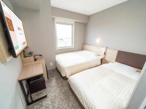 Postel nebo postele na pokoji v ubytování Super Hotel Shonan Fujisawaeki Minamiguchi