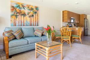 a living room with a couch and a table at Napili Surf Beach Resort in Lahaina